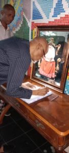 Dr. A. P Fovie, signing the condolence register during the visit